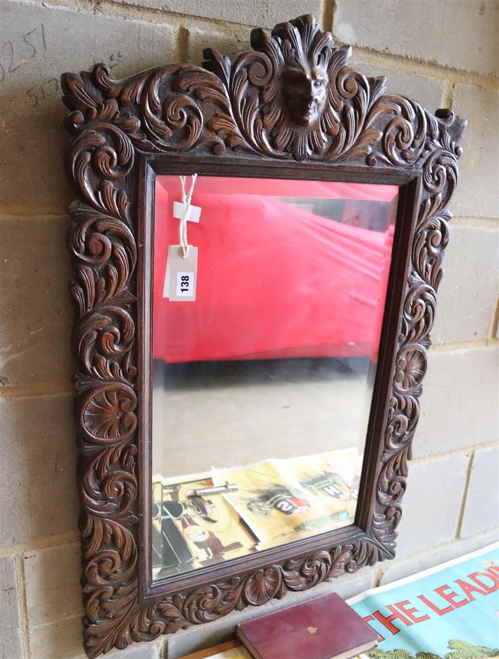 A late Victorian carved oak mirror, 60 x 90cm together with a late Victorian carved oak rope-twist aneroid barometer